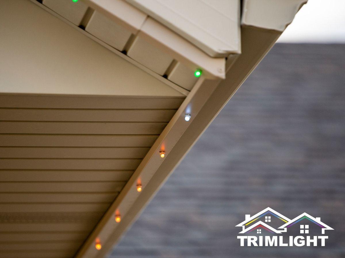 Close-up of Trimlight permanent LED lights in color-matched track under a soffit